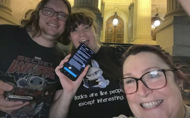 Self-guided city exploration game participants in front of Melbourne's historic building.