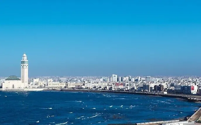 Casablanca skyline with Hassan II Mosque by the Atlantic Ocean.