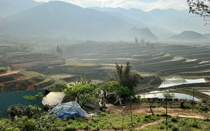 Terraced rice fields in Sapa with misty mountains in the background, Vietnam.