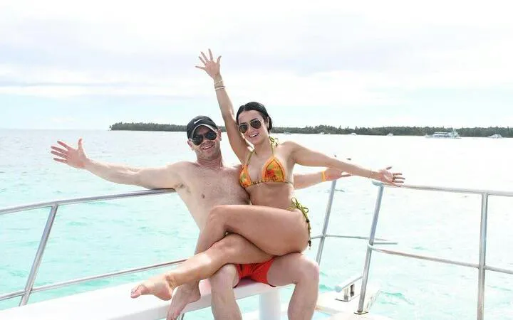 Couple enjoying Punta Cana sunset party boat cruise with open bar.