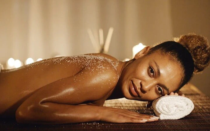 Woman enjoying a relaxing massage with exfoliation at a Moroccan hammam in Marrakesh.