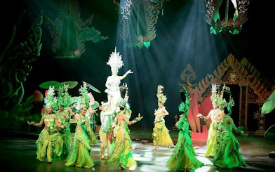 Performers in traditional costumes on stage at Colosseum Show Pattaya, Thailand.