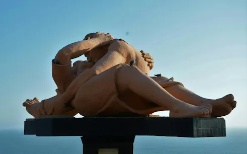 Sculpture of embracing couple at Parque del Amor, Miraflores, Lima, overlooking the ocean.