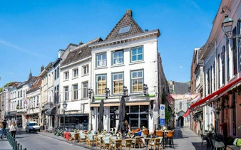 Outdoor café on a historic street in Breda during a self-guided audio walking tour.