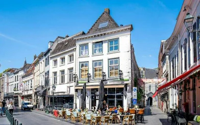 Outdoor café on a historic street in Breda during a self-guided audio walking tour.