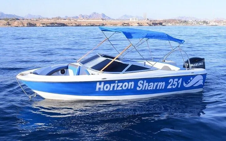 Private speedboat on Sharm El Sheikh shoreline with distant mountains.