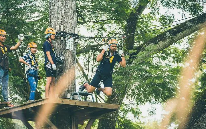 Zipline participants at Phoenix Adventure Park, Chiang Mai, preparing for a high rope course.