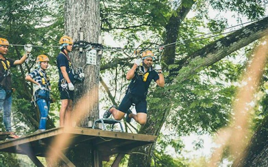Zipline participants at Phoenix Adventure Park, Chiang Mai, preparing for a high rope course.