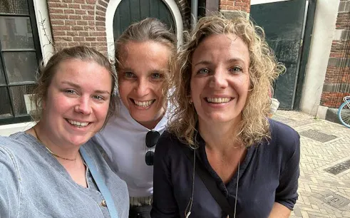 Three people smiling during the Utrecht Monster Mystery self-guided city exploration game.