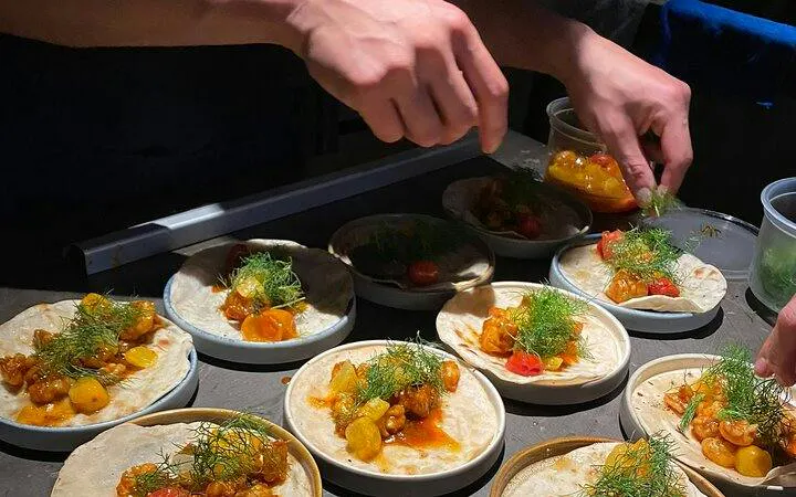 Tacos being prepared with fresh ingredients in Mexico City.