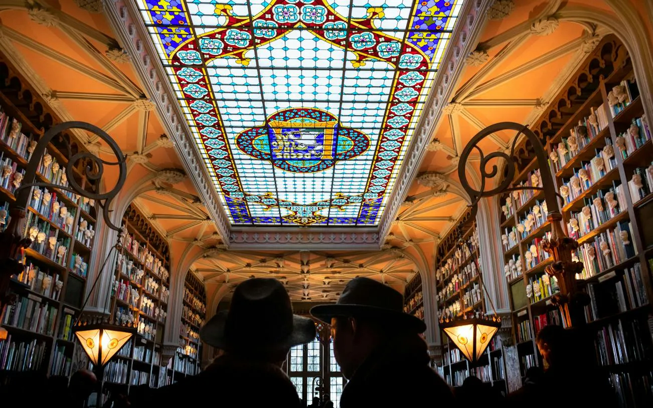 Stained glass ceiling and bookshelves in Livraria Lello, Porto Historic Center.