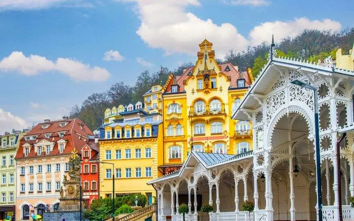Colorful historic buildings and ornate colonnade in Karlovy Vary, Czech Republic.