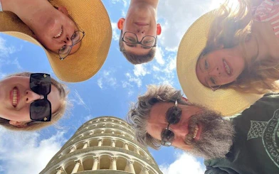 Group of tourists at the Leaning Tower of Pisa during a Tuscan day tour.