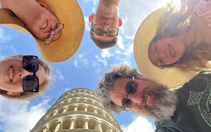Group of tourists at the Leaning Tower of Pisa during a Tuscan day tour.