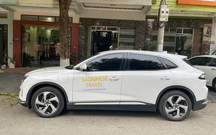 Private transfer vehicle for Sapa to Ninh Binh route parked on a street.