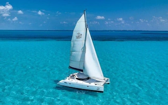 Catamaran sailing on turquoise waters near Isla Mujeres.