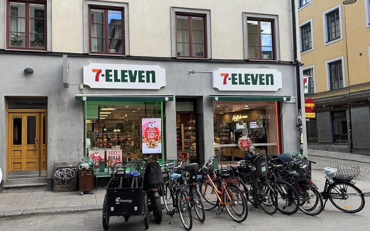 7-Eleven store with bicycles parked outside in Stockholm, part of The Millennium Trilogy Experience tour.
