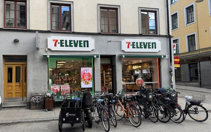 7-Eleven store with bicycles parked outside in Stockholm, part of The Millennium Trilogy Experience tour.