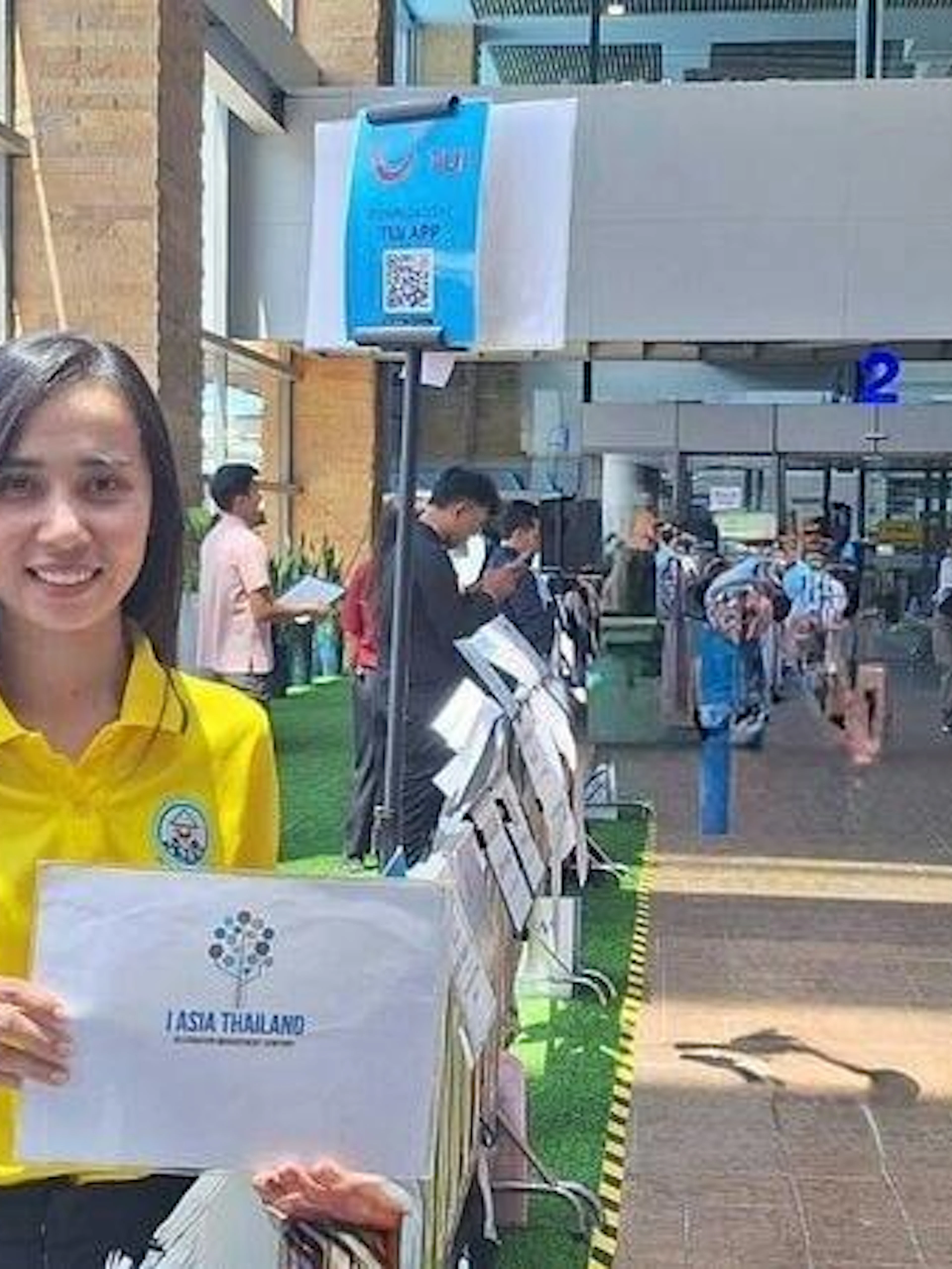 Phuket airport staff holding a sign for private transfer service to hotels in Phuket, Khao Lak, or Phang Nga.