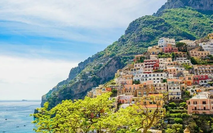 Amalfi Coast hillside village with colorful buildings and sea view.