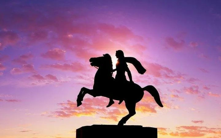 Equestrian statue silhouette at sunset, Thessaloniki self-guided walking tour.