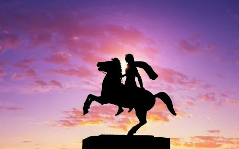 Equestrian statue silhouette at sunset, Thessaloniki self-guided walking tour.