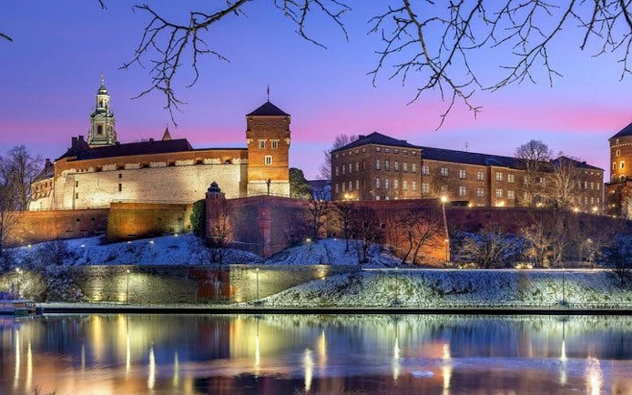 Wawel Castle at dusk reflected in the Vistula River, Krakow Self-Guided Walking Tour.