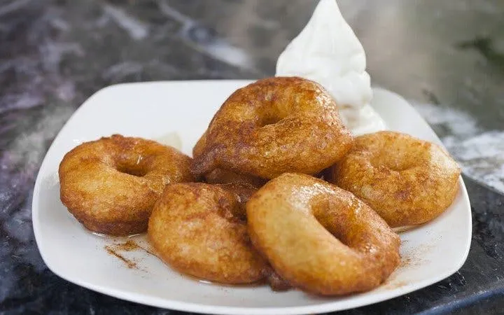 Loukoumades with honey and cinnamon on a plate, Athens food tour.