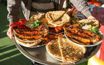 Traditional Turkish meal with grilled vegetables and flatbreads served on a tray during Cappadocia tour.