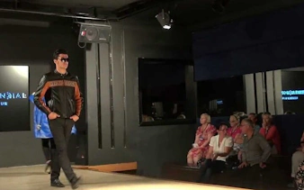 Fashion show in Cappadocia with audience seated, part of local producer shopping tour.