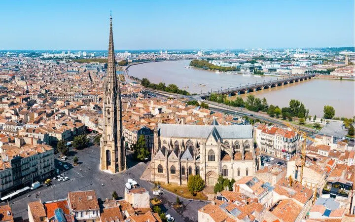 Aerial view of Bordeaux's Old Town with Saint-Michel Basilica and Garonne River.