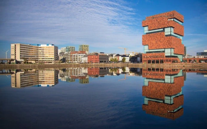 Museum aan de Stroom reflecting in the water, Antwerp self-guided walking tour.
