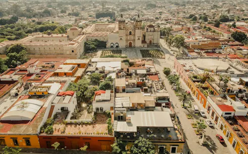 Aerial view of Oaxaca Historic Center with Santo Domingo Church and surrounding colorful buildings.