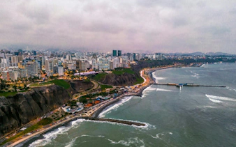 Aerial view of Lima's coastline and cityscape, featuring Barranco district, Peru.