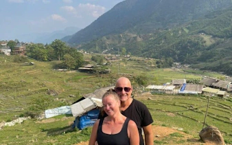 Couple enjoying Sapa's terraced rice fields during guided trek, Vietnam.