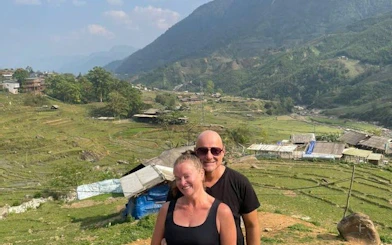 Couple enjoying Sapa's terraced rice fields during guided trek, Vietnam.