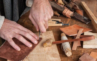 Artisan crafting leather goods in Oltrarno, Florence.