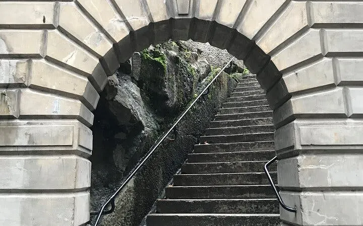 Stone archway leading to stairs in Sydney, part of Ghosts of Sydney exploration game.