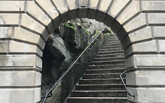 Stone archway leading to stairs in Sydney, part of Ghosts of Sydney exploration game.
