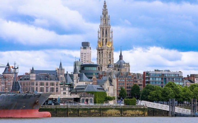Antwerp Cathedral and cityscape viewed from the river, featured in self-guided walking tour app.