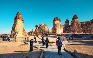 Tourists exploring Cappadocia's unique rock formations on a guided museum tour.