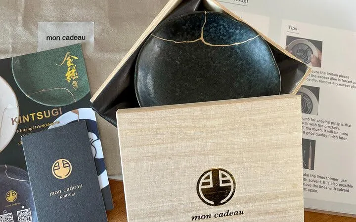 Kintsugi pottery kit with repaired bowl and instructions at Shibuya workshop.