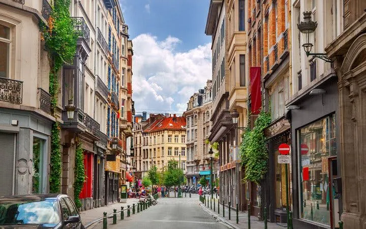 Brussels street view with historic buildings, part of the Capital of Comics self-guided city exploration game.