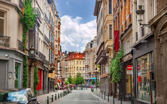 Brussels street view with historic buildings, part of the Capital of Comics self-guided city exploration game.