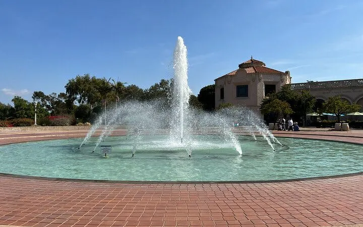 Fountain in Balboa Park, San Diego, with surrounding architecture and trees.