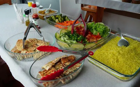 Buffet with grilled chicken, rice, and fresh salads on a snorkeling tour in Galapagos, Puerto Baquerizo Moreno.