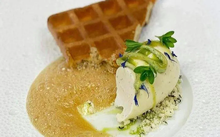 Waffle dessert with ice cream and sauce at Grand Hotel Oslo during Oslo Walking Tour.