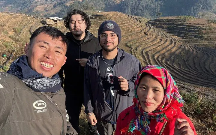 Group enjoying Mu Cang Chai rice terraces during private car tour from Sapa.