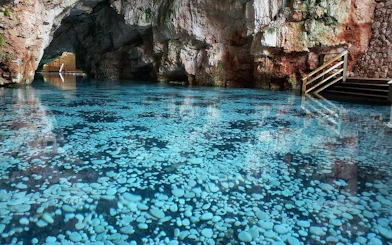 Cenote with clear blue water and rocky cave walls, Punta Cana.