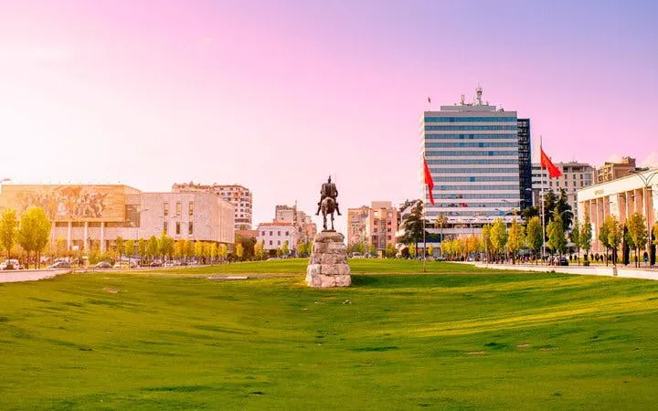Skanderbeg Square in Tirana with statue and surrounding buildings.
